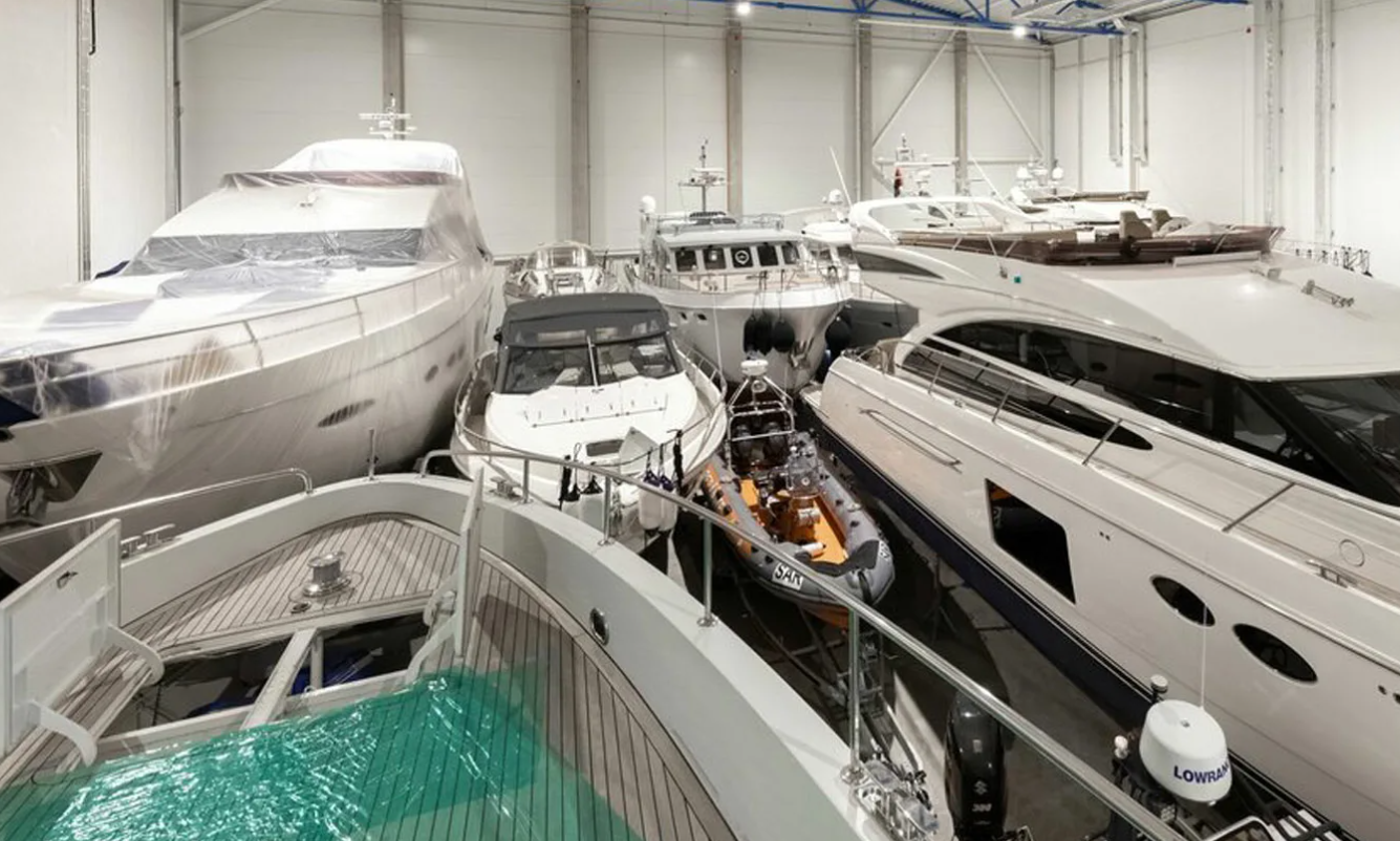 Marine crew preparing a yacht for launch after winter indoor storage